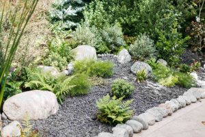 How do you prepare a rock garden area?