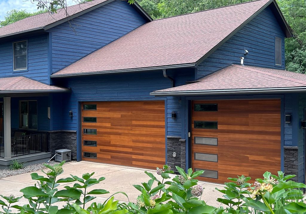 Modern and stylish garage doors ranging from rustic wooden designs to sleek futuristic finishes, showcasing the hottest styles of the year