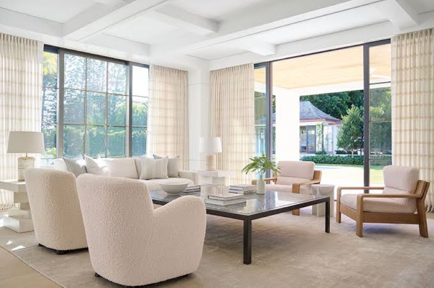 Bright home interior with decorative curtains installed on glass sliding doors